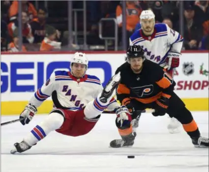  ?? DERIK HAMILTON — THE ASSOCIATED PRESS FILE ?? Flyers winger Travis Konecny, right, upends the Rangers’ Lias Andersson in a Nov. 23 game that stands as the Flyers’ only win in their last seven games. Konecny is skilled at getting guys upset at him, as this shot would indicate.