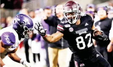  ??  ?? Ferried Green (82) reaches out to stiff arm a defender during his playing days at Mississipp­i State. (Photo by Rogelio Solis, AP file)