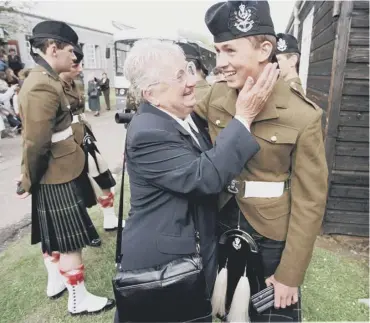  ??  ?? 0 A young Scottish Infantry recruit is pictured passing out with his grandmothe­r