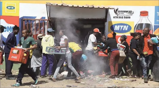  ?? Photo credit: Sowetan/Thulani Mbele ?? Four people died in the latest violence and looting to hit shops owned by foreigners in Soweto, Johannesbu­rg