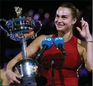  ?? ANDY WONG —THE ASSOCIATED PRESS ?? Aryna Sabalenka of Belarus holds the Daphne Akhurst Memorial Cup after defeating Zheng Qinwen of China in the women’s singles final at the Australian Open at Melbourne Park, Melbourne, Australia on Saturday.