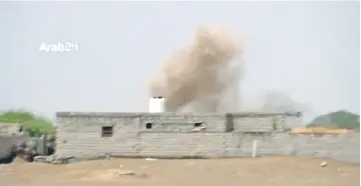  ?? — Reuters photo ?? Smoke rises from behind a building during heavy fighting between the Yemeni government and Houthis in Hodeidah, Yemen, in this still image taken from video.