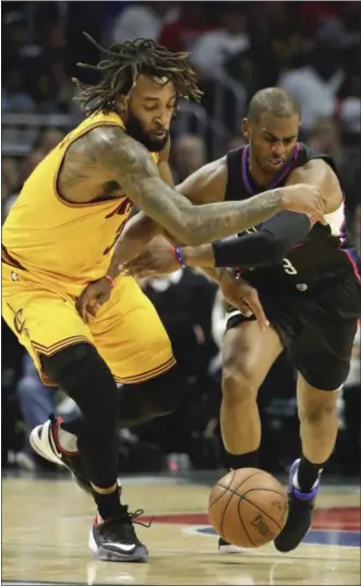 ?? JAE C. HONG — THE ASSOCIATED PRESS ?? The Clippers’ Chris Paul and the Cavaliers’ Derrick Williams go after the ball during the first half in Los Angeles on March 18.