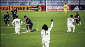  ?? AARON LAVINSKY — STAR TRIBUNE VIA AP, FILE ?? Players from the Minnesota United and Colorado Rapids take a knee, some raising a fist, during a moment of silence for racial justice, before an October match in St. Paul, Minn.