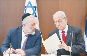  ?? (Kobi Gideon/GPO) ?? PRIME MINISTER Benjamin Netanyahu confers with Arye Deri in a cabinet meeting yesterday. Deri’s sacking will come into effect tomorrow morning.