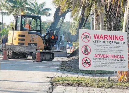  ?? JOE CAVARETTA / SOUTH FLORIDA SUN SENTINEL ?? A paving crew covers a repaired sewer break Tuesday at the 2500 block of Northeast 32nd Avenue in Fort Lauderdale. The sewage spill sent more than 1,000 gallons of raw sewage spewing into the neighborho­od overnight Sunday.