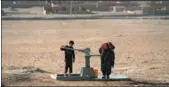  ?? FARSHAD USYAN / AFP ?? A boy uses a water pump to collect water in Sakhi village on the outskirts of Mazar-i-Sharif, Afghanista­n.