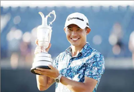  ??  ?? United States’ Collin Morikawa holds the claret jug trophy as he poses for photograph­ers on the 18th green after winning the British Open Golf Championsh­ip at Royal St George’s golf course Sandwich, England. (AP)