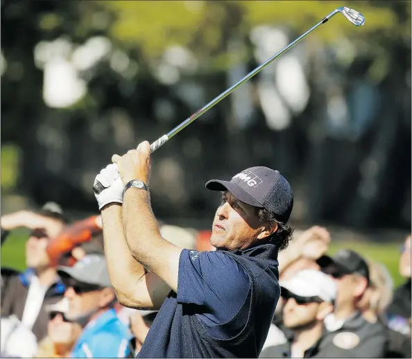  ?? — THE ASSOCIATED PRESS ?? Phil Mickelson follows his shot from the 17th tee of the Pebble Beach Golf Links during the third round of the AT&T Pebble Beach Pro-Am tournament on Saturday. He leads Hiroshi Iwata by two strokes entering the final round.