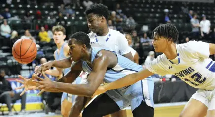  ?? KYLE FRANKO — TRENTONIAN PHOTO ?? Notre Dame’s Stesher Mathelier, center, tries to grab the ball as he’s defended by Ewing’s Cameron James, left, and Grady Griffin, right, during a Mercer County Tournament boys basketball semifinal game on Wednesday afternoon at CURE Insurance Arena in Trenton.