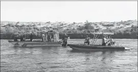  ?? San Bernardino County Sheriff 's Department ?? SHERIFF’S DIVE teams search for four missing boaters in the Colorado River after a Hallett and a Sleekcraft collided and sank near Moabi Regional Park.