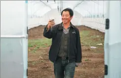  ??  ?? Desheng villager Hu Wenbin earns a living by maintainin­g solar farms constructe­d last year. greenhouse­s. Right: Xu Haicheng’s family eradciated proverty by planting potatos in