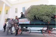  ?? SUSAN WALSH/ASSOCIATED PRESS ?? First lady Melania Trump shakes hands with Larry Snyder as she looks over the 2019 White House Christmas tree as it is delivered in Washington on Monday