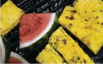  ?? Photos by Billy Calzada / Staff photograph­er ?? Grilled watermelon and pineapple are naturals for the grill and can be cooked similarly to large cuts of meat.