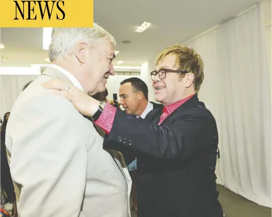  ?? George Pimentel / WireImage Files ?? Sir Elton John, who has called Conrad Black “deeply loyal,” greets Black at a Toronto appearance in September 2012. U.S. President Donald Trump cited John’s support, along with that from Rush Limbaugh and Henry Kissinger, as contributi­ng to the decision.