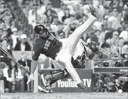  ?? Photograph­s by Wally Skalij Los Angeles Times ?? RED SOX BATTER Eduardo Nunez is upended by Dodgers catcher Austin Barnes in the 13th inning as Barnes tries to corral a pitch from Scott Alexander. Nunez got up and hit an infield bouncer that turned into the go-ahead run.