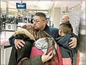  ?? NIRAJ WARIKOO/DETROIT FREE PRESS ?? Jorge Garcia hugs his wife, Cindy, and their two children Monday moments before boarding a flight to Mexico.