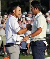 ?? CURTIS COMPTON — THE ASSOCIATED PRESS ?? Xander Schauffele, left, greets Hideki Matsuyama after Matsuyama won the 2021Master­s at Augusta National Golf Club on Sunday. Schauffele finished tied for third, three strokes back.