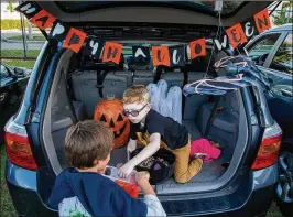  ?? ALLEN EYESTONE / THE PALM BEACH POST ?? River Shapiro, 6, of Wellington hands out candy during a trunk-or-treat event at the Boys & Girls Club of Wellington on Friday.