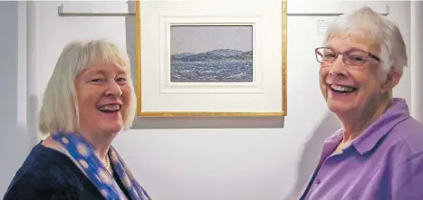  ?? WARD BASTIAN/HEFFEL ART AUCTION ?? Marit Mayne and Glenna Gardiner admire Tom Thomson’s Sketch for Lake in Algonquin Park at the Heffel Gallery in Vancouver. The painting sold for $481,250 at auction Wednesday, and Gardiner will be taking Mayne and her husband on a Mediterran­ean cruise.