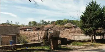  ?? JIM GAINES/JAMES.GAINES@COXINC.COM ?? Contractor­s clean up a years-old illegal landfill at 7365 Bishop Road in South Fulton last month. The land sold in June 2023, and the new Miami-based owner plans to use it as a storage site.