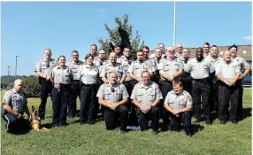  ?? MEGAN DAVIS MCDONALD COUNTY PRESS ?? Deputies with the McDonald County Sheriff’s Office stand in front of the iconic McDonald County Mustang. Shown are: front row from left, Brandon Barrett, Sheriff Michael Hall, and Chris Allison; second row from left, Tim Jeffers with K-9 Cresso, Becky...