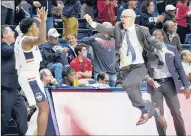  ?? CLOE POISSON/ HARTFORD COURANT ?? UConn coach Dan Hurley leaps along the sideline in reaction to a play in the second half of Sunday’s victory over the University of Missouri-Kansas City at Gampel Pavilion.
