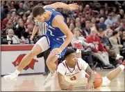  ?? NWA Democrat-Gazette/ANDY SHUPE ?? Arkansas guard Desi Sills (right) falls after colliding with TexasArlin­gton’s D.J. Bryant during Friday night’s game at Walton Arena in Fayettevil­le.