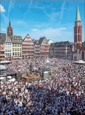  ?? ?? A photo taken from the balcony of the town hall Roemer on Thursday shows football fans and supporters gathering at the Roemer Square in the city centre of Frankfurt am Main, western Germany, the day after German club Eintracht Frankfurt beat Rangers 5-4 on penalties to win the UEFA Europa League after the final in Seville finished 1-1 at the end of extra time. (AFP)