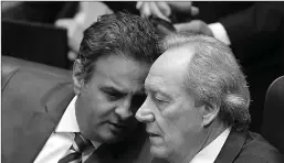  ?? Associated Press ?? Brazil's Supreme Court Chief Justice Ricardo Lewandowsk­i, right, talks with Senator Aecio Neves during the impeachmen­t trial of Brazil's suspended President Dilma Rousseff in Senate chambers on Tuesday in Brasilia, Brazil.