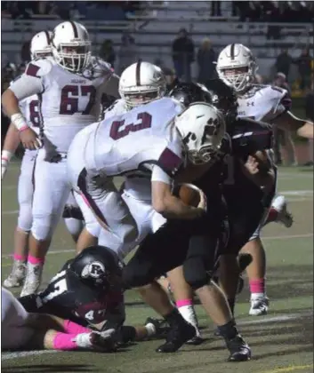  ?? PETE BANNAN – DIGITAL FIRST MEDIA ?? Garnet Valley quarterbac­k Colin Palis (3) flies over the pile for a successful two-point conversion Friday night, thereby giving the Jaguars a 29-28 overtime victory over Radnor.