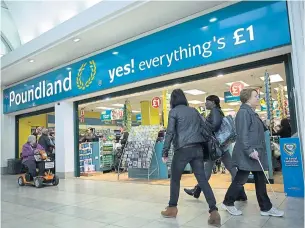  ?? BLOOMBERG ?? Pedestrian­s walk past the entrance to a Poundland discount store, operated by Poundland Group Plc in London.