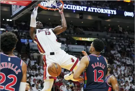  ?? MARTA LAVENDER - THE ASSOCIATED PRESS ?? Miami Heat center Bam Adebayo (13) dunks the ball over Philadelph­ia 76ers forward Tobias Harris (12) during the second half of Game 2of an NBA basketball second-round playoff series, Wednesday.