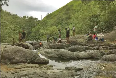  ??  ?? Cool off in the mountain stream at Mt Korobaba.