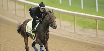  ?? CHARLIE RIEDEL/AP ?? Kentucky Derby entrant Messier works out at Churchill Downs Wednesday. Messier was previsouly trained by Bob Baffert, who was banned from Churchill Downs after last year’s winner, Medina Spirit, failed a post-race drug test.