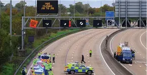  ?? ?? COP THE OIL: Police attend in numbers as protesters force the M25 to close