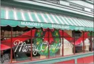  ?? LAUREN HALLIGAN — LHALLIGAN@TROYRECORD.COM ?? Manory’s Restaurant was one of many downtown businesses with elaborate window displays during the 35th annual Troy Victorian Stroll on Sunday in downtown Troy.