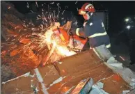  ?? YUANXIANG/ XINHUA XU ?? A firefighte­r cuts through debris to rescue victims of a landslide in Fangxian county, Hubei province on Thursday. Two people died after being hospitaliz­ed and three others dug themselves to safety.