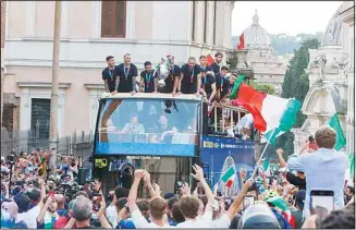  ??  ?? Italy’s players celebrate in Rome after their victory at the Euro 2020 soccer championsh­ips in a final played at Wembley stadium in London on Sunday. Italy beat England 3-2 in a penalty shootout after a 1-1 draw. (AP)
