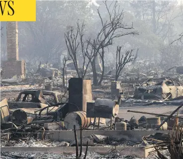  ?? ROBYN BECK / AFP / GETTY IMAGES ?? The aftermath of a wildfire that ripped through a Santa Rosa, Calif., neighbourh­ood is seen on Wednesday. The toll from Northern California’s wildfires continues to grow as officials said the fires killed at least 17 people.