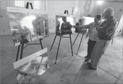  ?? TYLER BROWNBRIDG­E / The Windsor Star ?? Goldie and Bob Mitchell get a look at the University of Windsor’s plans for the future downtown buildings
during an open house at the downtown armouries on Thursday.