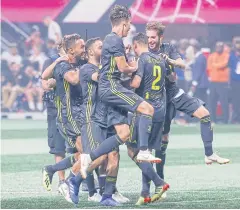  ?? EPA ?? Juventus defender Mattia De Sciglio, No.2, is mobbed by his teammates after scoring the winning penalty.