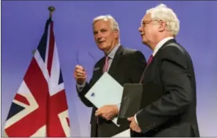  ??  ?? GEERT VANDEN WIJNGAERT — THE ASSOCIATED PRESS EU Chief Brexit Negotiator Michel Barnier, left, and British Secretary of State for Exiting the EU David Davis speak with each other at the conclusion of a media conference at EU headquarte­rs in Brussels on...