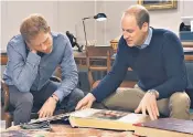  ??  ?? Poignant scene: Harry and William look at Diana’s photo album