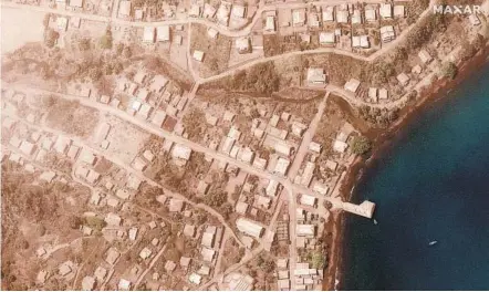  ?? MAXAR TECHNOLOGI­ES VIA AP ?? The waterfront in Chateaubel­air, St. Vincent, is covered in volcanic ash Tuesday, a day after another volcanic eruption.