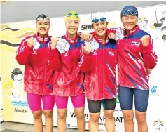 ??  ?? Sabah’s quartet is all smiles after winning silver in the women’s 4x100m freestyle relay.