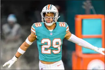  ?? DOUG MURRAY — THE ASSOCIATED PRESS ?? Miami Dolphins safety Brandon Jones runs onto the field during player introducti­ons against the Dallas Cowboys on Dec 24in Miami Gardens, Fla.