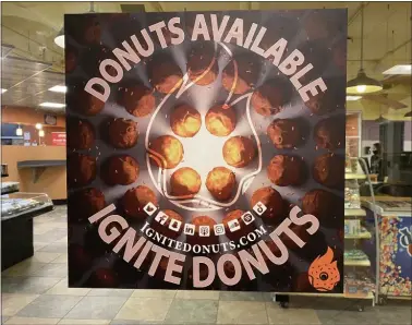  ?? PHOTO COURTESY OF IGNITE DONUTS ?? An Ignite Donuts sign in one of the CMU markets that sells their products.