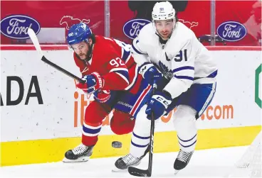  ?? ERIC BOLTE USA TODAY SPORTS ?? Toronto Maple Leafs forward John Tavares plays the puck and Montreal Canadiens forward Jonathan Drouin defends in the first period at the Bell Centre Wednesday.