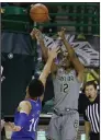  ?? (AP/Jerry Larson) ?? Baylor’s Jared Butler shoots a three-pointer over Kansas’ Jalen Wilson during Monday’s game in Waco, Texas. Butler scored a season-high 30 points to lead the No. 2 Bears over the No. 9 Jayhawks 77-69 to improve to 13-0 this season.